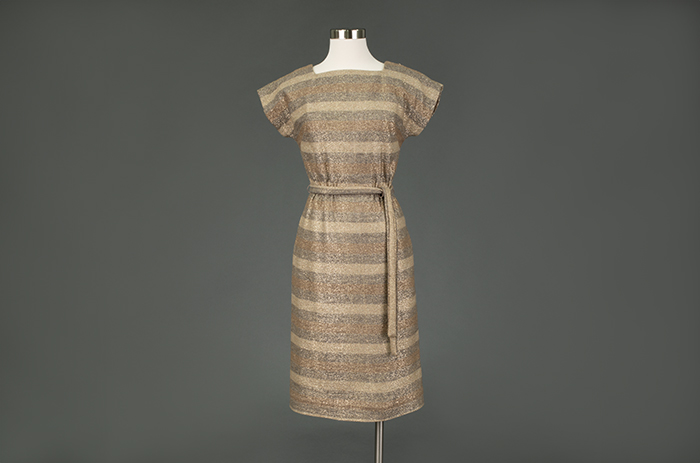 Image of Beige metallic dress, modeled in the Seattle World's Fair Fashion Pavilion, 1962